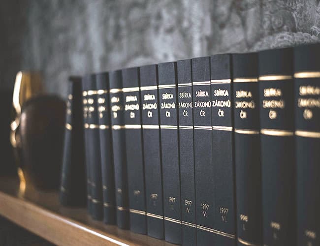 Volumes of the Czech Collection of Laws on the office bookshelf